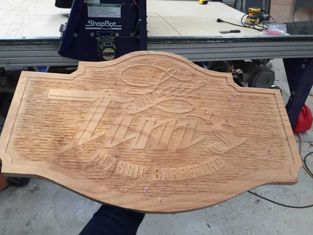 rough draft of a sign that says "little tim's classic barbering" with grooved background
